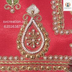 an embroidered red cloth with gold and white beads on the bottom, along with other accessories