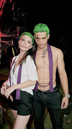 a man and woman with green hair standing next to each other