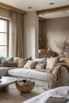 a living room filled with lots of furniture and pillows on top of a white couch