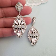 Hollywood Glam crystal earrings, made with top Swarovski rhinestones hand sett on silver filigree drop . finished with hypo allergenic surgical steal ear wire. Original design , hand crafted by me in my studio. Light weigh and very comfortable to wear . Other related accessories are coming soon ( necklace) Suggested Bracelet: https://www.etsy.com/listing/721178495/white-opal-wedding-cuff-bracelet-crystal?ref=shop_home_active_7 Please contact me if you have any questions. Dazzling White Teardrop Crystal Earrings, Crystal Chandelier Earrings With Sparkling Stones As Gift, White Crystal Chandelier Earrings With Rhinestones, White Crystal Chandelier Earrings For Formal Occasions, Crystal Embellished Dangle Earrings, Formal White Crystal Chandelier Earrings, Sparkling Silver Crystal Bridal Earrings, Dazzling White Crystal Dangle Earrings, Diamond White Crystal Chandelier Dangle Earrings