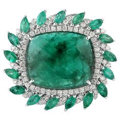 This stunning ring has been crafted from 18-karat gold. It is set with 8.89 carats emerald and .51 carats of glittering diamonds. The ring is a size 7 and may be resized to larger or smaller upon request. FOLLOW MEGHNA JEWELS storefront to view the latest collection & exclusive pieces. Meghna Jewels is proudly rated as a Top Seller on 1stDibs with 5 star customer reviews. All items manufactured by us are handmade and can be customized or redesigned. Composition Size-US-7 Total Weight-11.06 Gold Opal Diamond Ring, Tanzanite Diamond Ring, Emerald Diamond Ring, Tanzanite Diamond, White Gold Set, Colorless Diamond, Diamond Glitter, Diamond Cocktail Rings, Vs Diamond