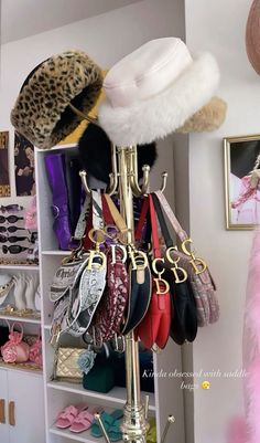 a rack with hats and purses on it in a room filled with other items