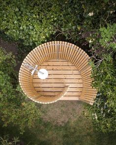 an overhead view of a wooden bench in the grass