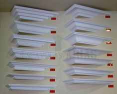 several rows of white shelves with red labels on the top and bottom, all lined up against a wall