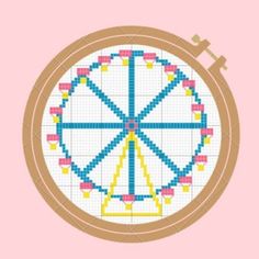 a cross stitch ferris wheel on a pink background