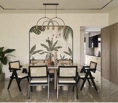 a dining room table with chairs and a painting on the wall in the back ground