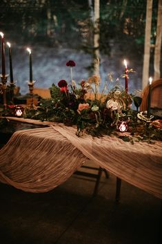 a table with candles and flowers on it