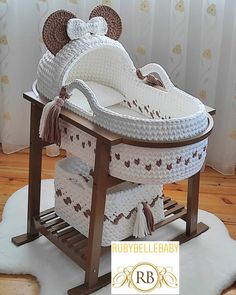 a crocheted baby's cradle with mouse ears on the top and bottom