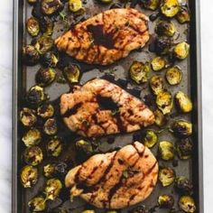 grilled chicken and brussel sprouts on a baking sheet