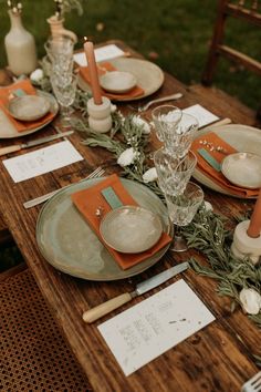 the table is set with plates and place settings