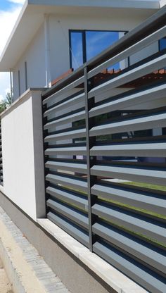 the side of a house with a metal fence