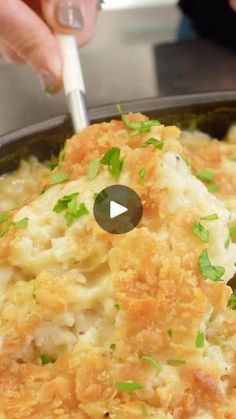 a person is cooking some food in a skillet with a white spatula and green garnishes