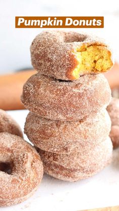 a stack of doughnuts sitting on top of a white table next to each other