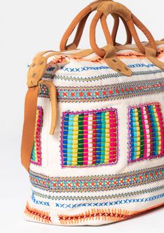 Travel in style with this ultra-bohemian weekender travel bag. A colorful statement piece featuring embroidered details, a zip-top closure, and suede trim. The large carry-all size is perfect for last-minute getaways. Embroidered Stitch details Zip-top closure Suede leather top handles Leather shoulder strap Bohemian weekender bag Dimensions: 24" X 17 3/4"Style: DR-8474 Bohemian Rectangular Duffle Bag For Weekend Trips, Bohemian Style Rectangular Duffle Bag For Weekend Trips, Bohemian Weekender Bag For Weekend Trips, Bohemian Rectangular Weekender Bag With Luggage Sleeve, Bohemian Travel Duffle Bag With Luggage Sleeve, Bohemian Satchel Duffle Bag For Trips, Bohemian Duffle Bag With Leather Handles, Bohemian Rectangular Bag With Luggage Sleeve, Bohemian Rectangular Duffle Bag With Leather Handles