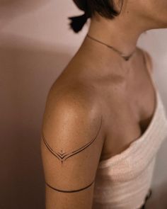 a woman with a tattoo on her shoulder