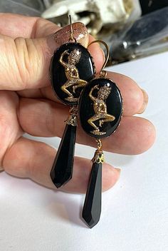 "These elegant glass reverse painted Siamese dancer , they have 1900's black glass drops dangling from them. They measure approx. 3 1/3\" tall with the brass wires.  You will receive this exact pair. As with all vintage pieces, they are not machine made and therefor not perfect (My kind of thing :-) Most of my earrings are one of a kind as these beads and vintage pieces that I use are hard to come by. I use a combination of vintage pieces that I find and pieces that I make. My handmade pieces do not have a perfect machine made look. It is a quality which I love. Each piece will be carefully boxed and will be around for generations to come." Artistic Black Dangle Earrings, Artistic Black Drop Earrings, Artistic Black Dangle Jewelry, Artistic Black Jewelry With Matching Earrings, Artistic Black Collectible Jewelry, Handmade Victorian Black Earrings, Victorian Black Earrings For Party, Buddha Earrings, Dark Academia Jewelry