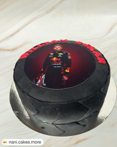 a black cake with a red and yellow photo on it