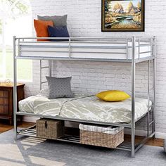 a metal bunk bed sitting in a bedroom next to a wall mounted painting on the wall