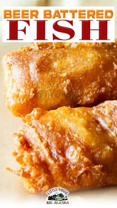 two pieces of fried fish sitting on top of a white plate with the words beer battered fish