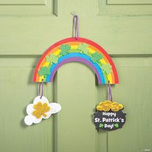 a st patrick's day door hanger with shamrocks and a rainbow