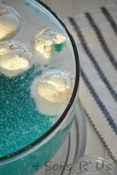 some food is in a glass bowl on a table with a white and blue towel