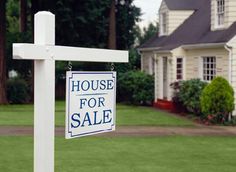 a real estate with a bad neighbor sign in the foreground and a house in the background