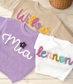 Our custom hand embroidered name sweaters are sure to look adorable on the sweet little one in your life!  Give them as gifts for baby showers, name announcements, first birthday's, Xmas gifts, and more!  Sweaters are a chunky knit and an oversized fit to wear as your baby grows.  These are perfect to wear in the fall, winter, or spring. Choose the color and size of your sweater in the above drop down.  Choose how many letters are in the name you want embroidered.  Fill in the personalization box with the name and thread color of your liking. Care Instructions Sweaters are made of 100% cotton.  Embroidery is made of 100% acrylic yarn.  We recommend to wash sweater inside out on delicate setting.  Do not wash with anything that has zippers, velcro, or heavy items to ensure your sweater last Playful White Knitted Top, Cute White Sweater With Embroidered Text, White Cute Sweater With Embroidered Text, Cute Embroidered Knit Tops, Customizable Cute Winter Sweater, Cute Customizable Winter Sweater, Cute Cotton Sweater With Embroidered Logo, Cute Sweater With Letter Embroidery For Fall, Cute Winter Sweater With Letter Embroidery