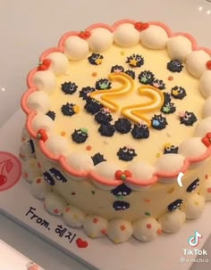 a birthday cake with white frosting and colorful decorations