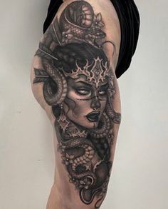 a woman's leg with tattoos on it and an image of a snake in the middle