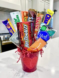 a cup filled with candy and candies on top of a counter