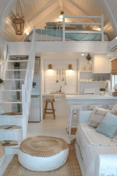 a room with white walls and floors has a loft bed