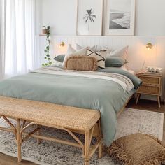 a bedroom with a bed, dresser and two framed pictures on the wall above it