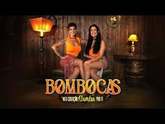 two women sitting next to each other in front of a wooden wall with the words bombocas written on it