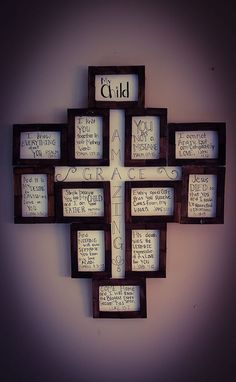 a cross made out of wooden blocks with writing on the sides and words below it