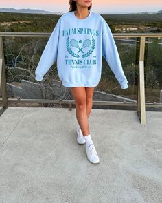 Palm Springs Tennis Club Sweatshirt. Each one is printed to order using non-toxic inks and made under eco-friendly, sweatshop-free and ethical working conditions. A sturdy and warm sweatshirt bound to keep you warm in the colder months. A pre-shrunk, classic fit sweater that's made with air-jet spun yarn for a soft feel. This is a unisex sweatshirt, not fitted. Check the size chart for your perfect fit! ✦ 50/50 cotton/polyester ✦ Colors: White, Ash, Sand, Light Blue, Light Pink ✦ Pre-shrunk ✦ Cl Casual Printed Crew Neck Sweatshirt, Printed Crew Neck Casual Sweatshirt, Spring Crew Neck Sweatshirt With Text Print, Crew Neck Sweatshirt With Text Print For Spring, Trendy Printed Crew Neck Sweatshirt, Trendy Comfortable Sweatshirt With Graphic Print, Trendy Comfortable Fit Sweatshirt With Graphic Print, Blue Text Print Sweatshirt For Spring, Trendy College Sweatshirt With Screen Print