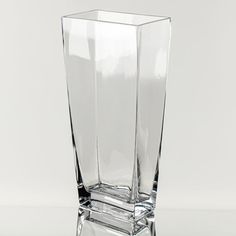 a tall glass vase sitting on top of a table