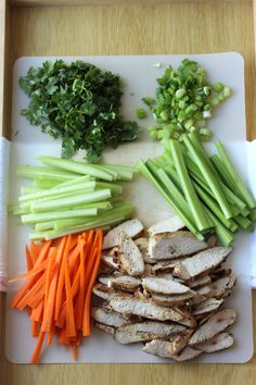 the cutting board has carrots, celery and meat