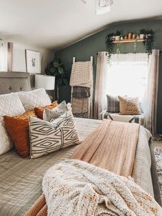 a large bed sitting under a window in a bedroom