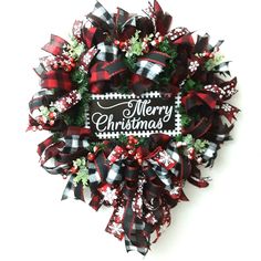 a red and black wreath with merry christmas written on it