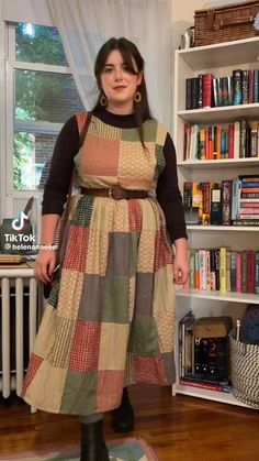 a woman standing in front of a bookshelf