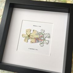 a piece of puzzle sitting in a black frame