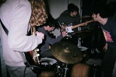 a group of people playing instruments in a room