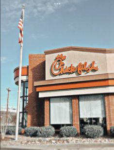 the exterior of a fast food restaurant with an american flag