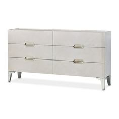 a white dresser with four drawers and metal legs