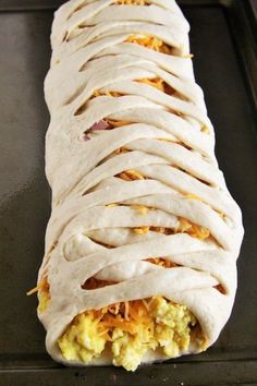 an uncooked burrito sitting on top of a pan