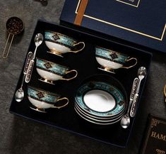 a blue and white porcelain dinner set in a gift box with gold trimmings