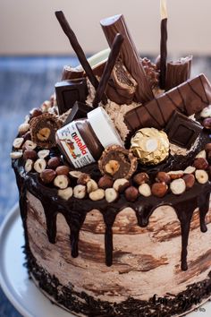 a cake with chocolate, nuts and marshmallows on it