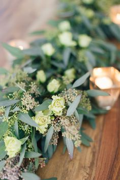 flowers and greenery are lined up on the table