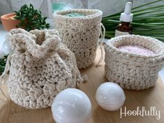 three crocheted bags sitting on top of a wooden table next to an egg