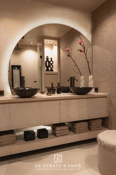 a bathroom with two sinks and a large mirror